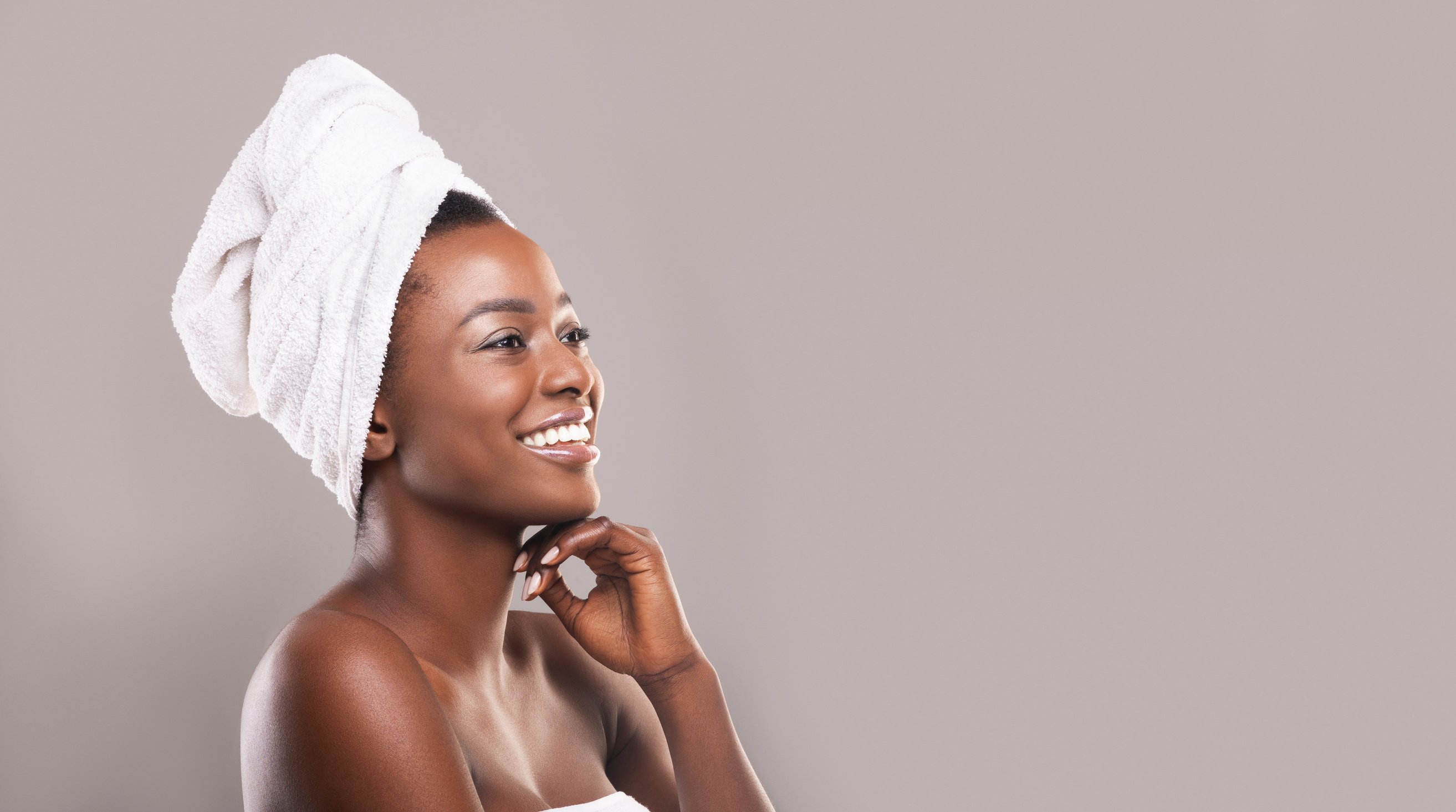 Beautiful african woman with towel on head and glowing skin